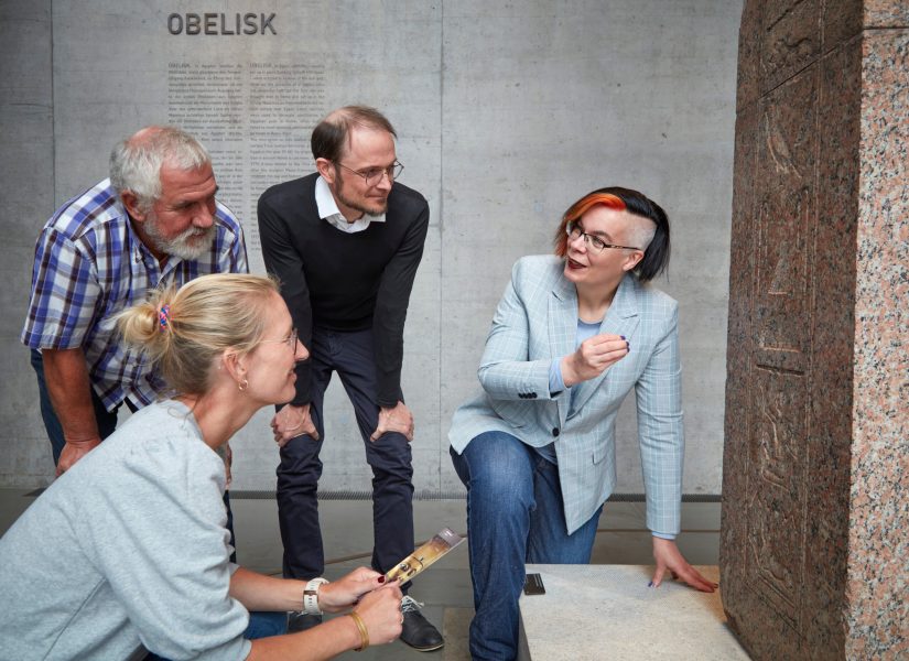 Roxane führt eine Gruppe Menschen im Museum